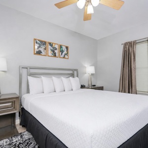 Drift into relaxation in this serene guest bedroom, adorned with plush queen bedding and inviting decor for restful nights