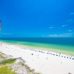 Beach view from the balcony overlooking the pristine pristine white sand and vibrant blue waters