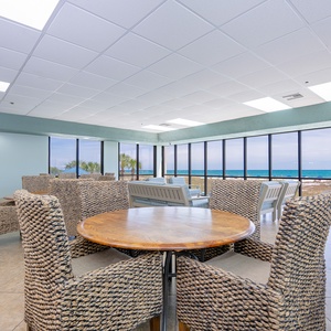 Relax in this bright common area with beach views, cozy seating, and a coffee bar perfect for gathering with friends