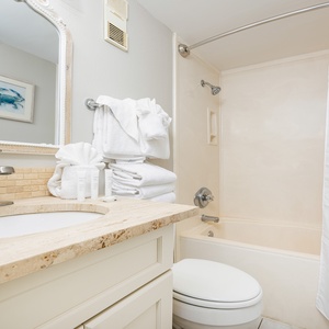 Pamper yourself in the stylish bath, complete with fluffy towels and a relaxing tub for unwinding after beach days