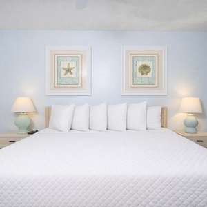 Drift off in the king master suite, surrounded by beach decor that invites peaceful slumber and sweet dreams