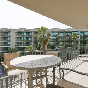 Bask in tropical breezes while enjoying views of the pool from the cozy seating on your retreat