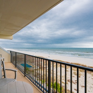 This balcony offers stunning beach views with comfortable seating for relaxation and enjoying the coastal scenery