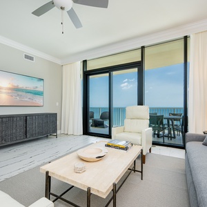 Unwind in this elegant living space featuring stylish seating, a large TV, and stunning views