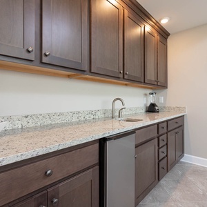 Enjoy crafting refreshing drinks at the sleek wet bar, perfect for unwinding after a day at the beach