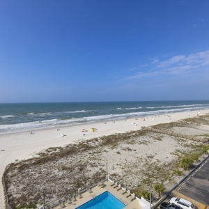 Enjoy stunning beachfront views and a refreshing pool from this inviting outdoor space