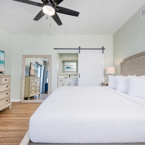 King bed in the master suite welcomes you to unwind while the TV offers relaxing entertainment options