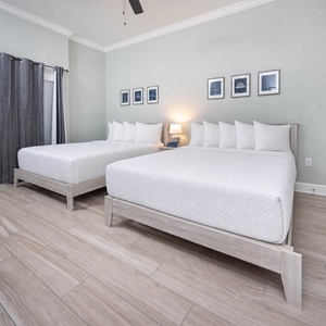Relax on one of the cozy queen beds in this guest suite and enjoy a peaceful slumber