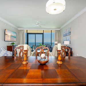 Gather around the elegant dining table for family meals or game night with a beachfront view