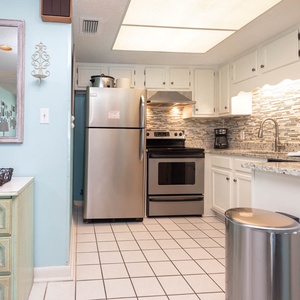 This kitchen features granite countertops, stainless appliances, and a coffee maker, perfect for your culinary adventures