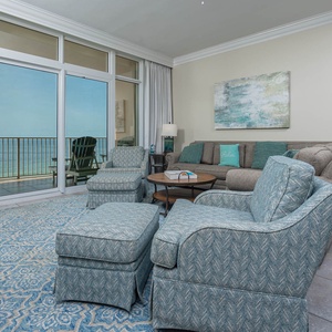 Unwind in the spacious living area featuring comfortable seating and beautiful beachfront views