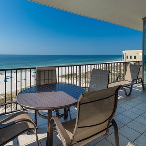 Relax on the private balcony with inviting seating and breathtaking views of the pristine beach and tranquil waters