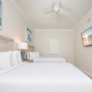 Unwind in this inviting bedroom with your favorite show after a day of fun at the beach