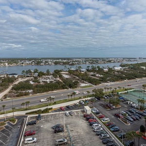 Scenic view of the bay with boats docked from the master balcony, surrounded by lush greenery and offering a tranquil vibe