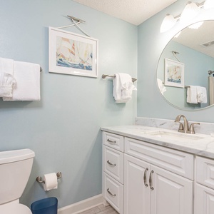 Refresh in this guest bathroom featuring a marbled countertop, stylish decor, and nautical accents for a relaxing experience