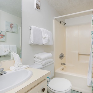Refresh in this cheerful bathroom, preparing for beach adventures with fresh towels at your fingertips