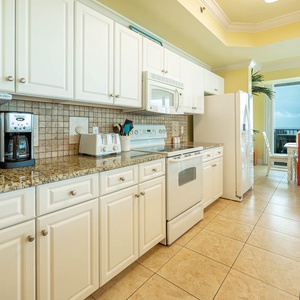 Prepare meals in the spacious kitchen featuring granite countertops and stylish coffee corner