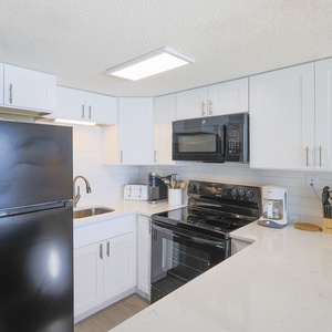 This kitchen features modern appliances and a bright, inviting atmosphere perfect for meal preparation and gatherings