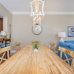Dine at the rustic wooden table, surrounded by comfortable seating and charming decor