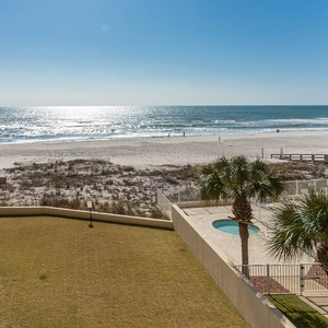 Enjoy breathtaking views of the beach from your private balcony, surrounded by lush palm trees and inviting outdoor spaces