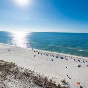Take in the serene views of the sparkling water and beach, perfect for relaxation and outdoor activities