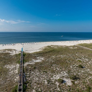 Impressive view of the beach with white sand, lounge chairs, and a serene gulf, inviting relaxation and enjoyment