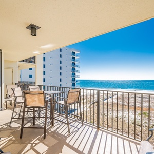Balcony seating offers a serene spot to enjoy the sparkling gulf view and gentle sea breeze, perfect for relaxation