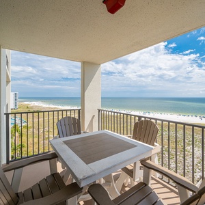 Balcony seating offers a relaxing spot to enjoy the expansive view of the beach and gulf beyond