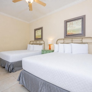 Inviting guest bedroom featuring two comfortable queen beds and charming decor, perfect for a relaxing getaway