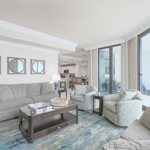 Relax in the inviting living area with sofa and queen sleeper, a coffee table, and views of the beachfront balcony