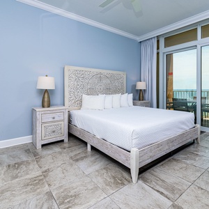 Retreat to the king master suite with cozy bedding and drift off to the sound of the waves from the balcony