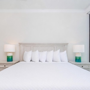 Experience comfort in this king guest suite featuring a large bed and stunning coastal views