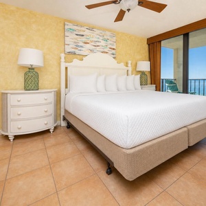 Master bedroom featuring a plush king bed and a beautiful view from the sliding glass doors