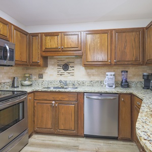 Craft your favorite family meals surrounded by natural wood cabinetry and granite counters, perfect for family bonding
