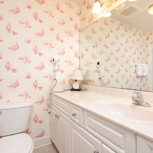 Freshen up in this guest bath in the relaxing shower or soothing tub before an exciting beach day