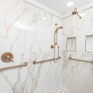 Enjoy a refreshing shower in the elegant space in the master bath featuring stylish tile and rainfall showerhead
