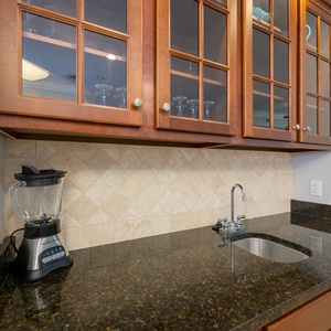 Blend refreshing drinks with ease at the sleek wet bar, enhancing your vacation vibe with every sip