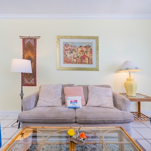 Soft cushions invite you to sink into the living room sofa and unwind after a day on the coast