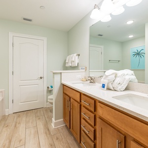Refresh in the master bath after a day at the beach with a soothing jetted tub and relaxing walk-in shower