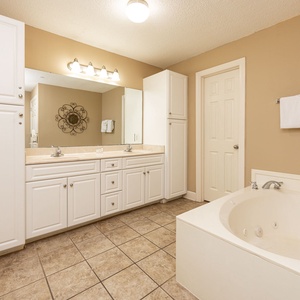 Indulge in relaxation in the master bath with a refreshing walk-in shower and soothing jetted tub