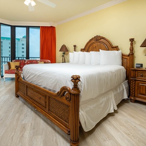 Spacious master suite featuring a king bed, vibrant decor, and large windows for a refreshing beach view