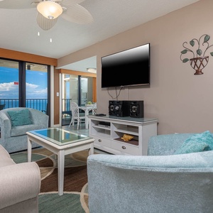 Inviting living area with plush seating , queen sleeper-sofa, and a stunning view of the sparkling waters from the balcony