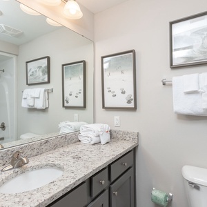 Freshen up in this guest bath in the relaxing shower or soothing tub before an exciting beach day