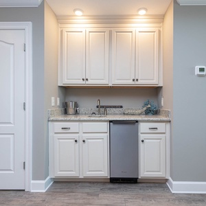 Enjoy a refreshing drink from the sleek wet bar, perfect for toasting to your beachfront escape