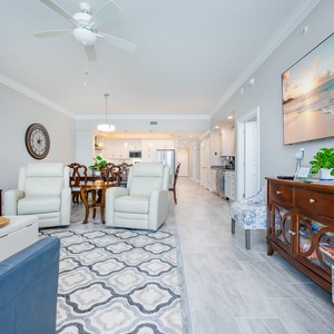 Relax in the spacious living area with comfortable seating, stylish decor, and coastal vibe