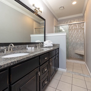 Begin your day in the master bath with a  spacious granite vanity and a stylish walk-in shower