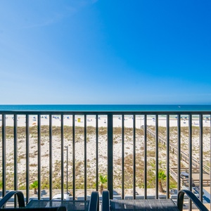 Relax in your chairs on the balcony, soaking in the sun and stunning beach views that enhance your getaway vibe