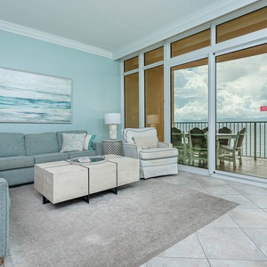 Sink into the plush sofa, featuring a queen sleeper, and enjoy tranquil views of the coast from the balcony