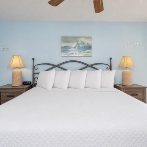Gentle lamp glow warms your king master suite as you unwind beneath the ceiling fan breeze