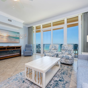 Relax in the living room as soft lamplight glows and the gulf sparkles beyond the glass doors